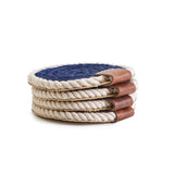 Set of four rope coasters with different color combinations on a white background