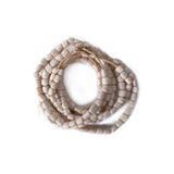 A set of four decorative white bone bead strands placed on a white background