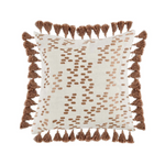 A square decorative pillow with light brown tassels and metallic embroidery on a light complexion background with dark accents.