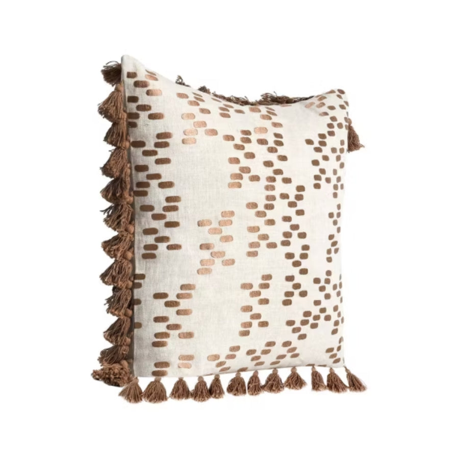 Decorative pillow with brown tassels on a white background