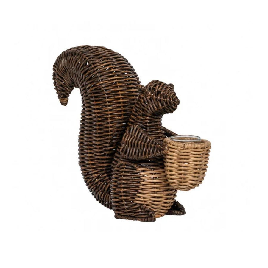 Wicker squirrel figurine holding a nut on a white background