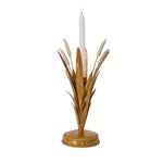 Decorative candle holder with gold leaves and a white candle on a white background