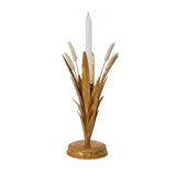 Decorative candle holder with gold leaves and a white candle on a white background