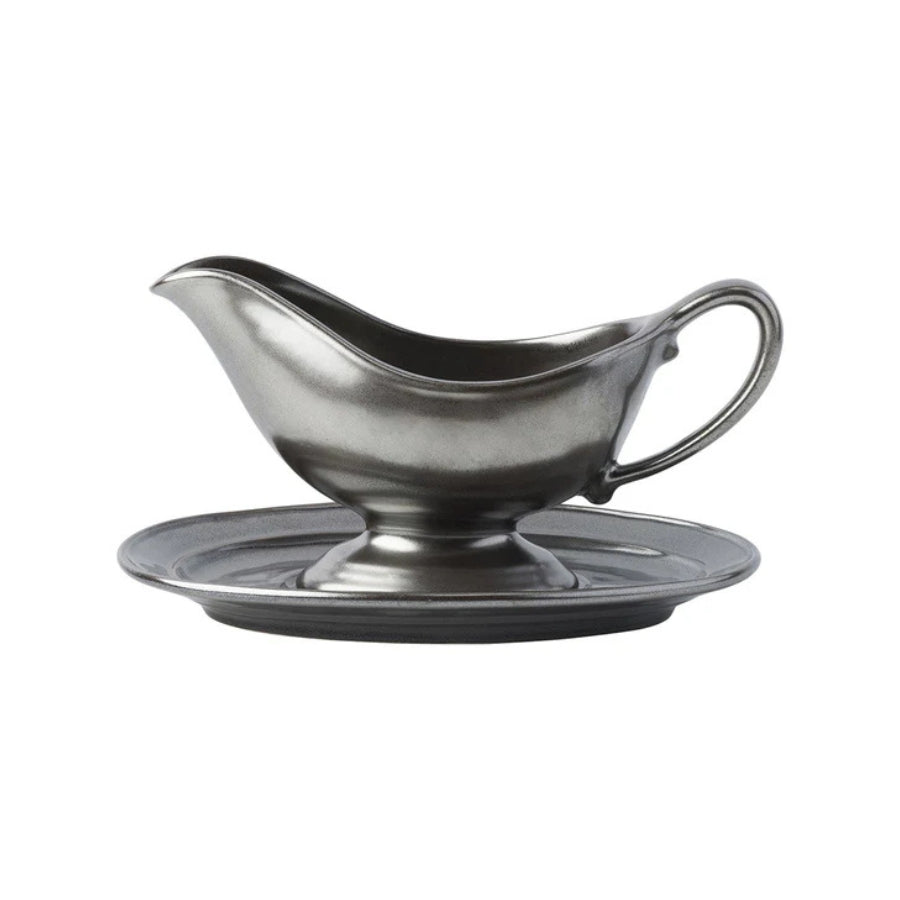 Gray gravy boat with matching saucer on a white background