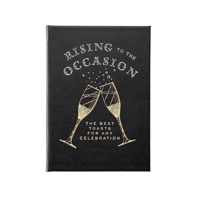 A book titled 'Rising to the Occasion' with a subtitle 'The Best Celebration Quotes' featuring a black cover and a graphic of two champagne glasses.