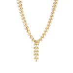 Gold necklace with leaf-like designs on a white background