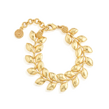 Gold bracelet with leaf design on a white background