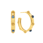 Gold hoop earrings with blue gemstones on a white background
