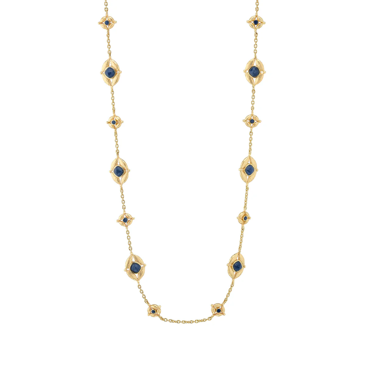 Gold necklace with blue gemstones on a white background