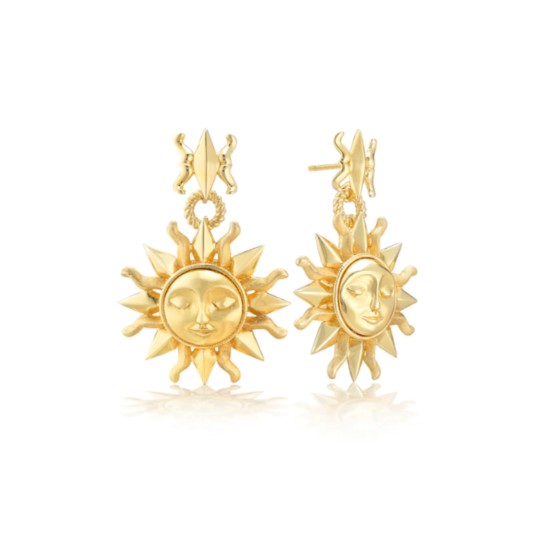Gold sun-shaped earrings with face design on a white background
