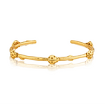 Gold open cuff bracelet on a white background