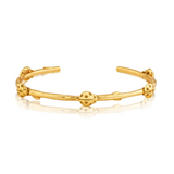 Gold open cuff bracelet on a white background