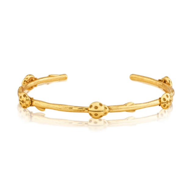 Gold open cuff bracelet on a white background