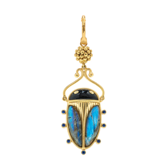 Gold beetle-shaped earring with blue stone on a white background