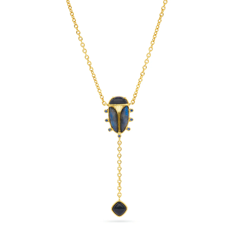 Gold necklace with a blue pendant on a white background
