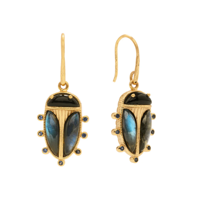 Gold earrings with blue gemstones on a white background