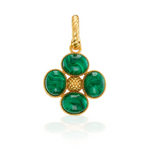 Gold pendant with green gemstones on a white background