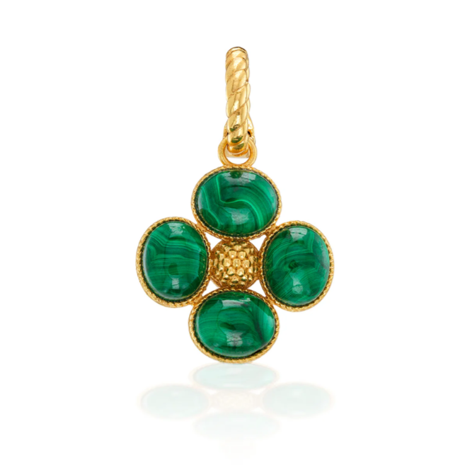 Gold pendant with green gemstones on a white background