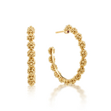 Gold hoop earrings with bead detailing on a white background
