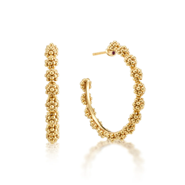 Gold hoop earrings with bead detailing on a white background