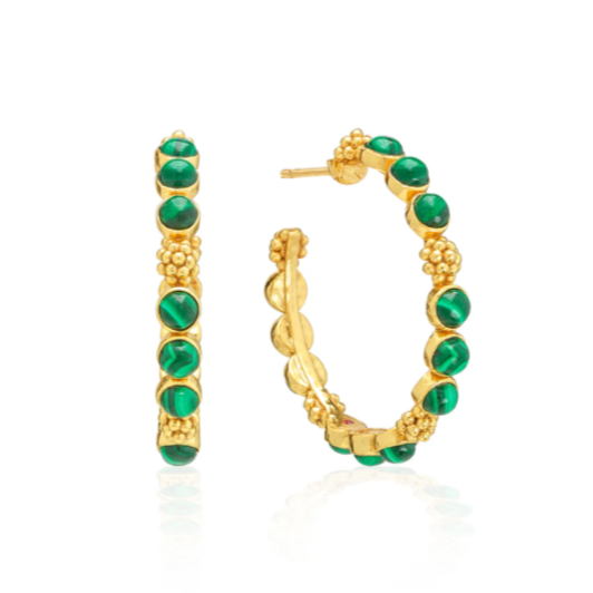 Gold hoop earrings with green gemstones on a white background